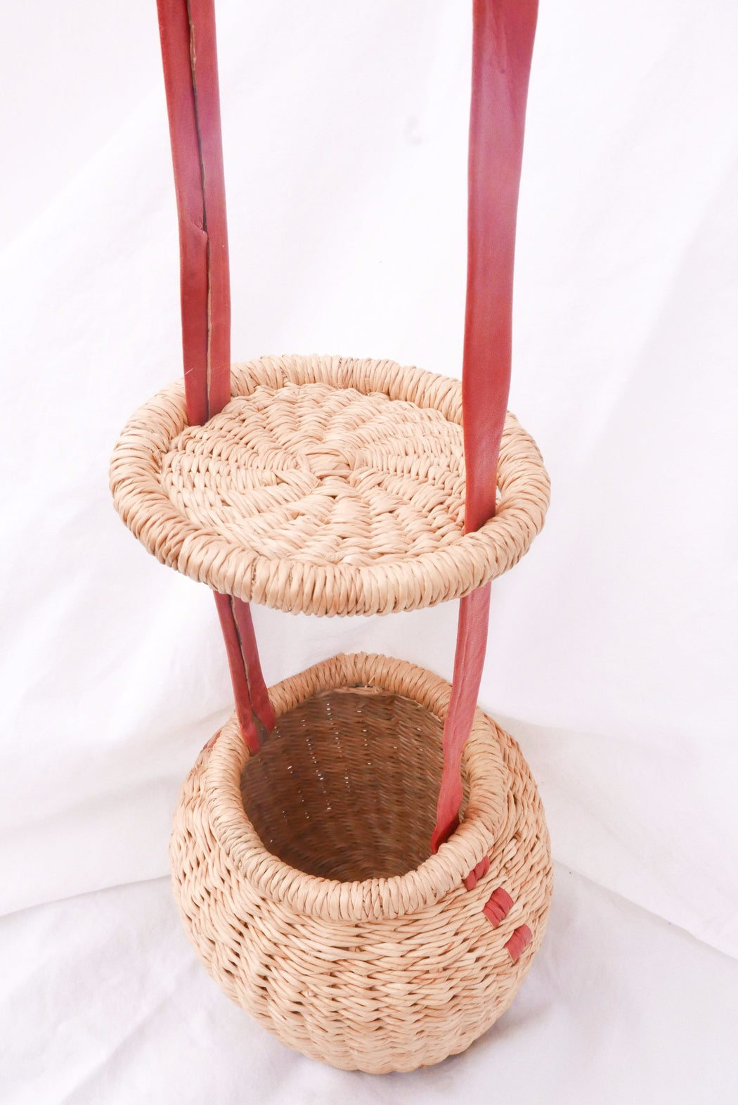 The natural Alobahe handbag is handwoven with straw called Kinkahe in Sherigu, Ghana. The shape is versatile and opens from the lid lifted vertical with an adjustable leather strap that can be worn as a crossbody or a handheld bag. This product supports a community with employment, educational opportunities for the children and improve the work environment.